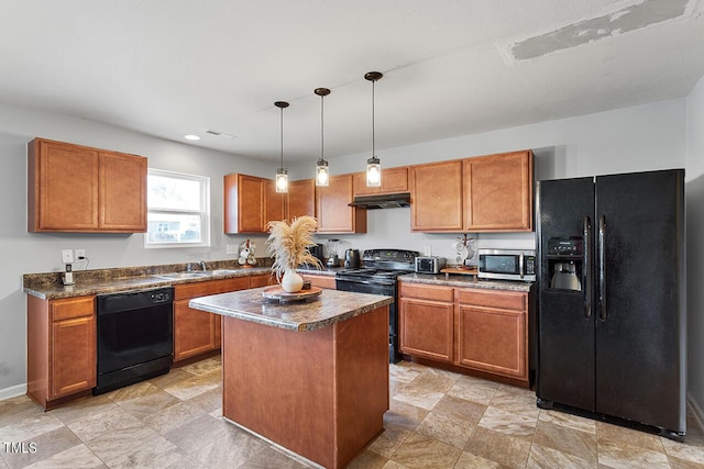 kitchen with black appliances, under cabinet range hood, a sink, and dark countertops