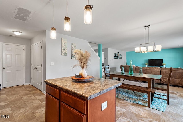 kitchen with a center island, open floor plan, decorative light fixtures, and brown cabinets