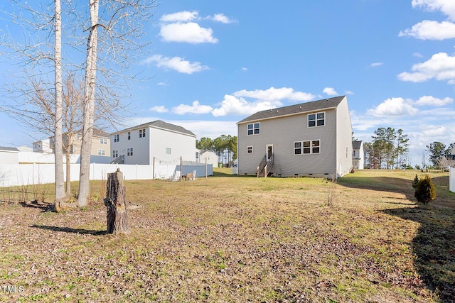 rear view of property featuring crawl space and a residential view