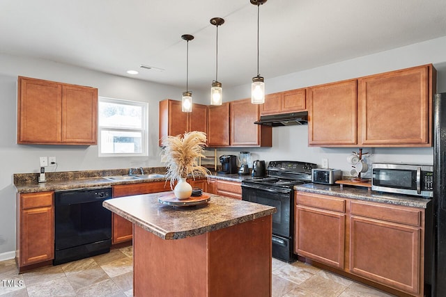 kitchen with black appliances, under cabinet range hood, dark countertops, a sink, and a center island