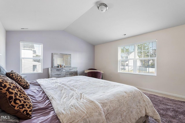 carpeted bedroom with multiple windows, lofted ceiling, and baseboards