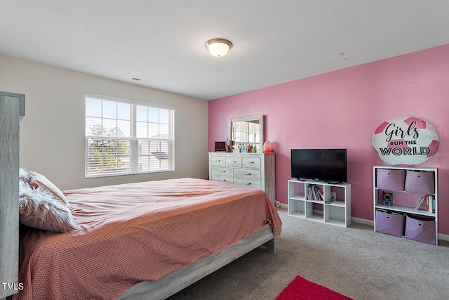 bedroom featuring carpet and baseboards