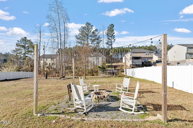 view of yard with an outdoor fire pit and a residential view