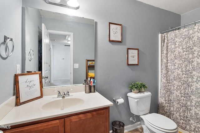 full bathroom with toilet, vanity, and a shower with shower curtain