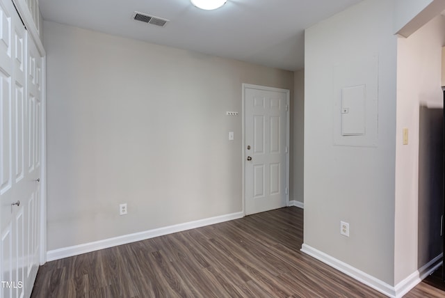 600 Audubon Lake Dr Unit 6B13, Durham, NC 27713 - unfurnished room with baseboards, dark wood-type flooring, and electric panel