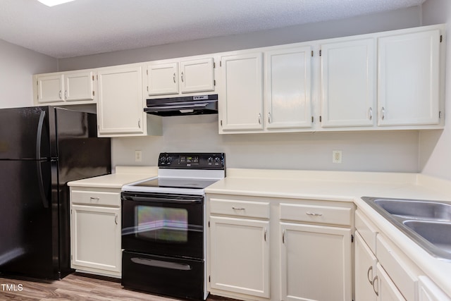600 Audubon Lake Dr Unit 6B13, Durham, NC 27713 - kitchen with electric stove, extractor fan, freestanding refrigerator, white cabinets, and wood finished floors