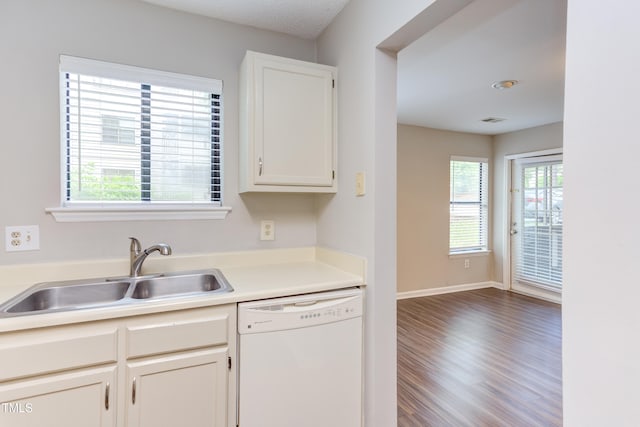 600 Audubon Lake Dr Unit 6B13, Durham, NC 27713 - kitchen with white dishwasher, a sink, wood finished floors, white cabinetry, and light countertops