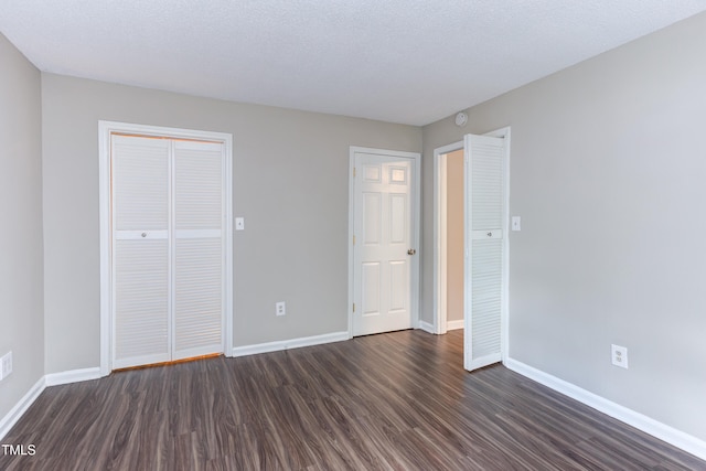 600 Audubon Lake Dr Unit 6B13, Durham, NC 27713 - unfurnished bedroom with dark wood-type flooring, baseboards, and a closet