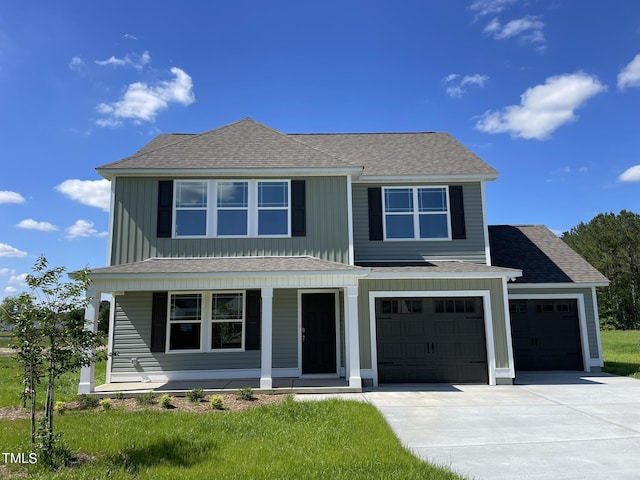 traditional home with board and batten siding, a garage, a shingled roof, concrete driveway, and a porch