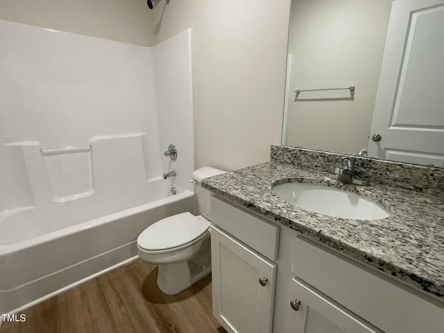 full bath featuring vanity,  shower combination, toilet, and wood finished floors
