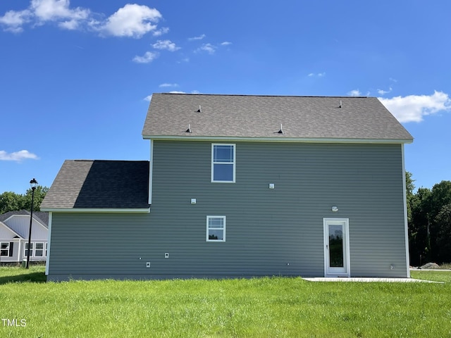 rear view of house with a lawn