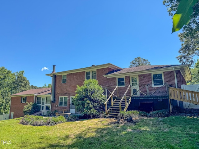 view of front of home with brick siding, stairs, and a front lawn