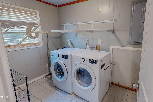 washroom featuring separate washer and dryer, electric panel, crown molding, and baseboards