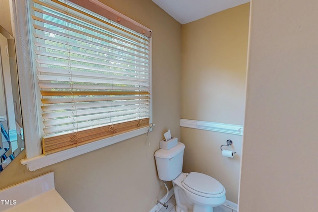 bathroom with toilet and baseboards