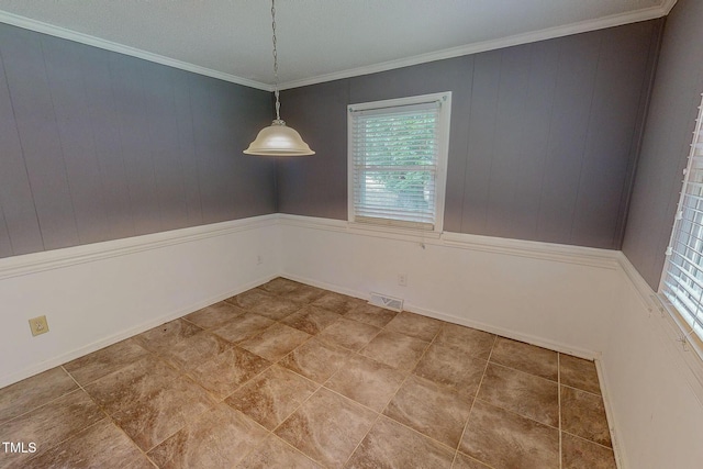 unfurnished dining area with plenty of natural light and crown molding