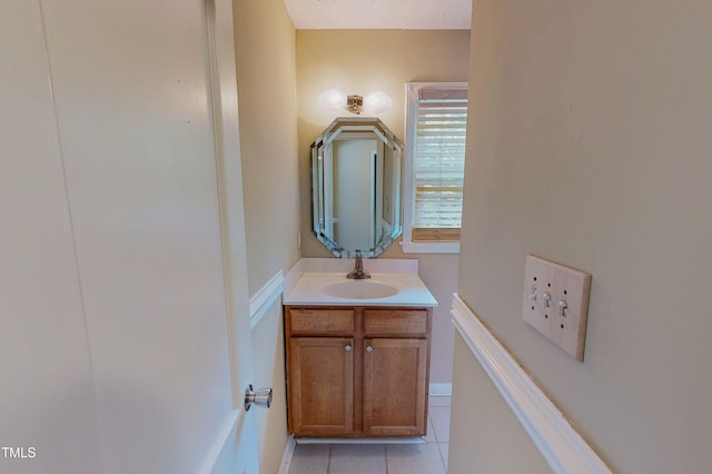 bathroom with tile patterned flooring and vanity