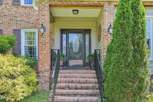 property entrance with brick siding