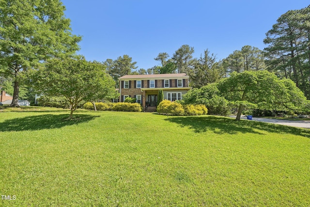 view of front facade featuring a front lawn and brick siding
