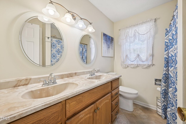 full bath with toilet, double vanity, tile patterned floors, and baseboards