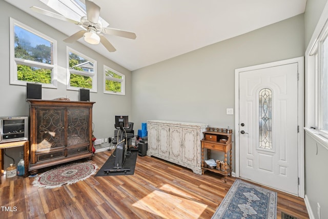foyer entrance with wood finished floors, ceiling fan, and lofted ceiling