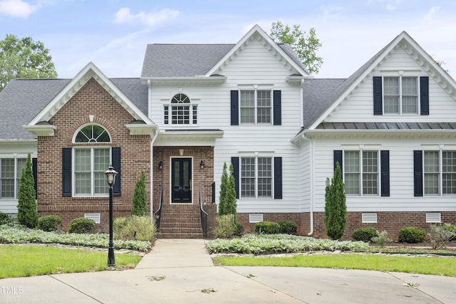 4812 Cornoustie Ct, Holly Springs, NC 27540 - view of front facade with a standing seam roof, roof with shingles, and brick siding