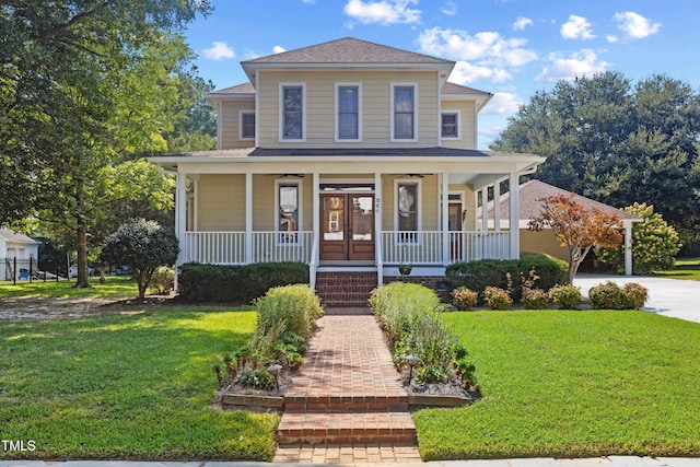 207 N Hopkins Ave, Spring Hope, NC 27882 - view of front facade featuring covered porch, a front yard, driveway, and a shingled roof