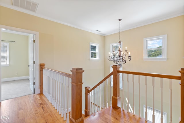 207 N Hopkins Ave, Spring Hope, NC 27882 - stairs with wood finished floors, a chandelier, crown molding, and baseboards