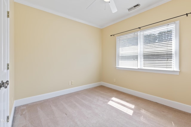 207 N Hopkins Ave, Spring Hope, NC 27882 - spare room featuring crown molding, carpet flooring, a ceiling fan, and baseboards