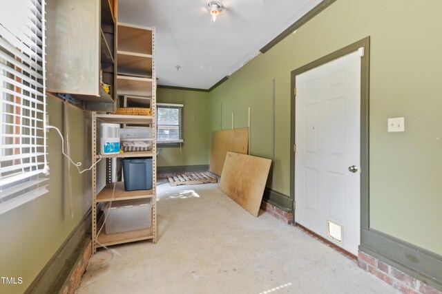 207 N Hopkins Ave, Spring Hope, NC 27882 - kitchen featuring crown molding, open shelves, and concrete flooring