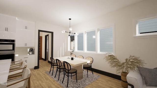 dining space with light wood-style floors and baseboards
