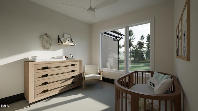 bedroom with multiple windows, a crib, light colored carpet, and ceiling fan