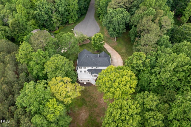 aerial view of property's location featuring a heavily wooded area