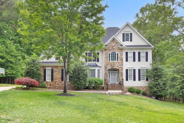 view of front of property featuring stone siding and a front yard