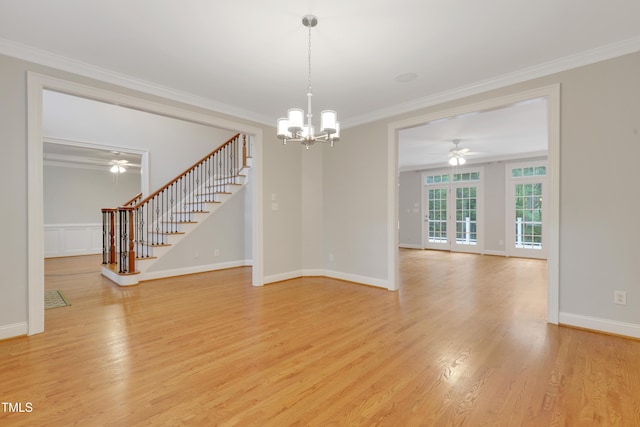 spare room featuring stairway, a chandelier, a ceiling fan, ornamental molding, and light wood-style flooring