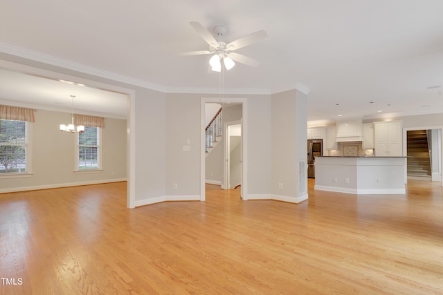unfurnished living room featuring stairway, light wood finished floors, ceiling fan, and crown molding