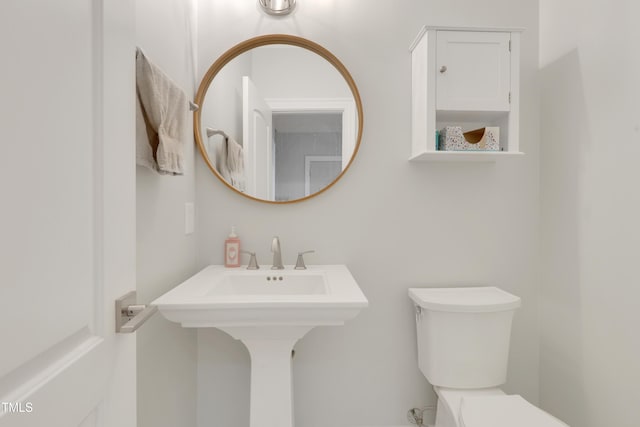 bathroom featuring toilet and a sink