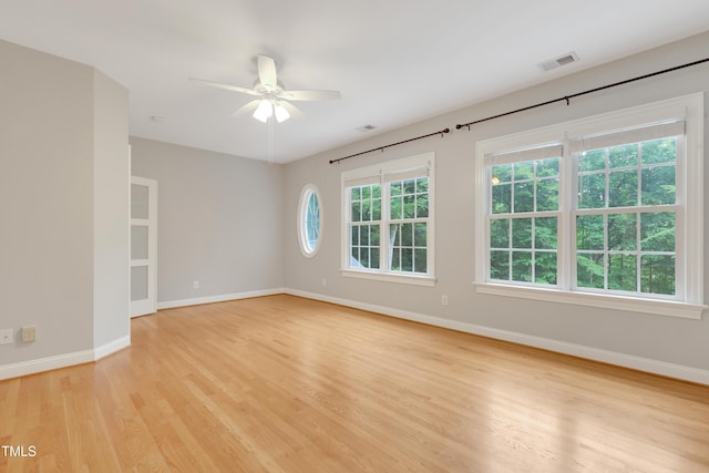 unfurnished room featuring light wood finished floors, baseboards, and a ceiling fan