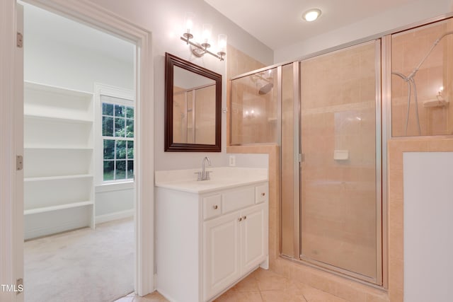 full bath with a stall shower, vanity, and tile patterned floors