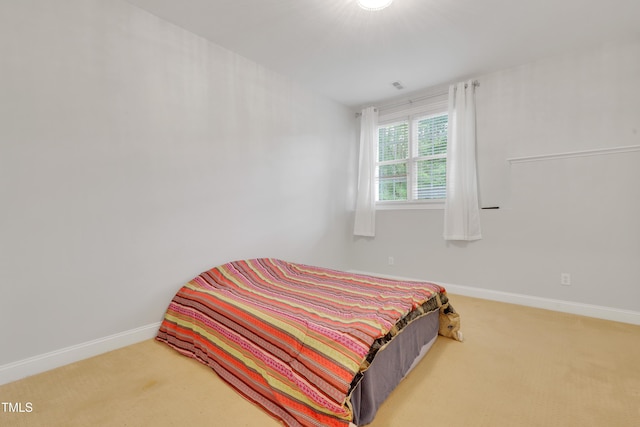 carpeted bedroom featuring baseboards