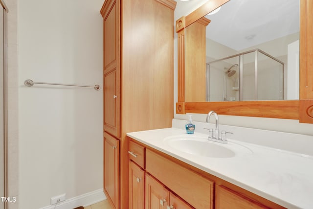 bathroom featuring a stall shower and vanity