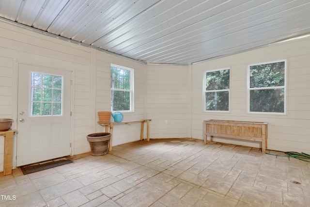 unfurnished sunroom with plenty of natural light