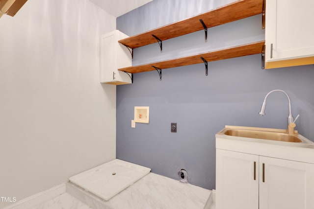 clothes washing area featuring hookup for an electric dryer, washer hookup, marble look tiles, and cabinet space