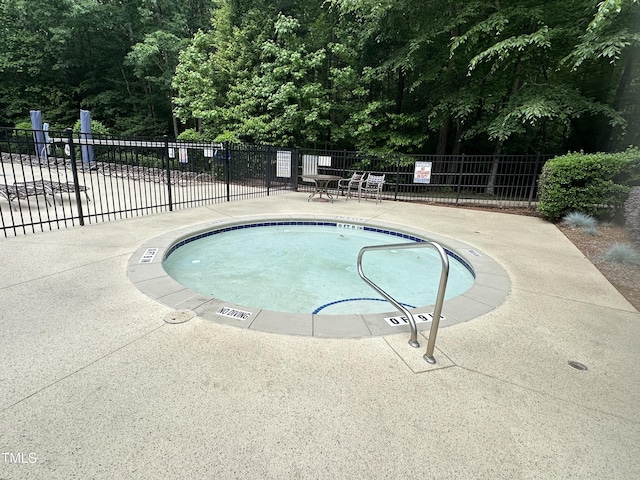 view of swimming pool with fence, a swimming pool, and a patio area