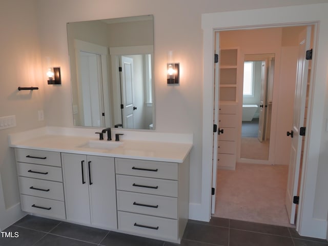 bathroom with vanity, tile patterned floors, and baseboards