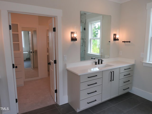 bathroom featuring vanity, baseboards, a stall shower, and tile patterned flooring
