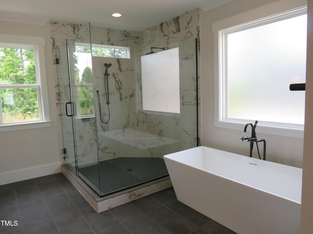 bathroom with a marble finish shower, tile patterned floors, a freestanding bath, recessed lighting, and baseboards