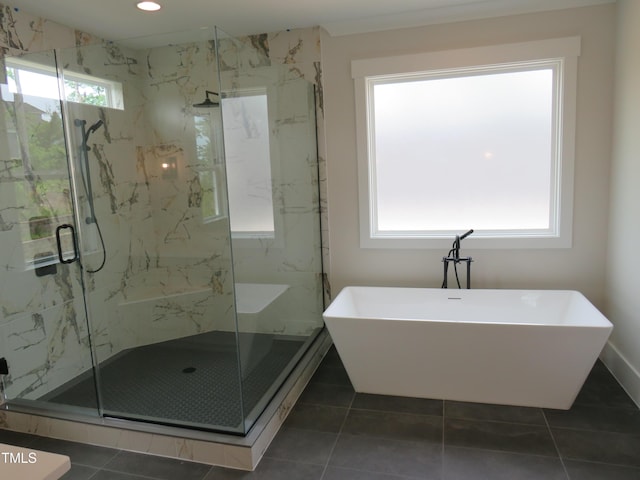 bathroom with a marble finish shower, a soaking tub, and recessed lighting