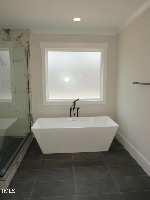 full bathroom featuring a marble finish shower, a freestanding tub, baseboards, and recessed lighting