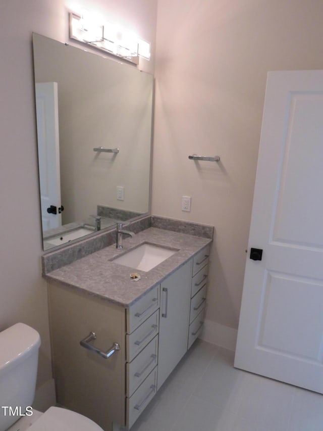 bathroom with vanity, tile patterned flooring, and toilet