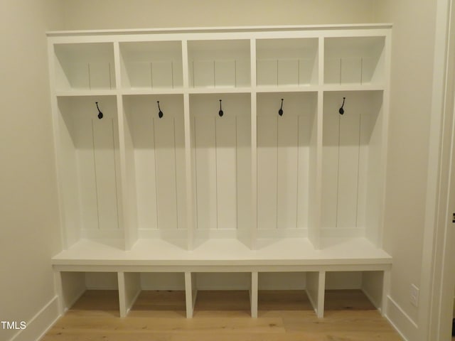 mudroom with wood finished floors and baseboards